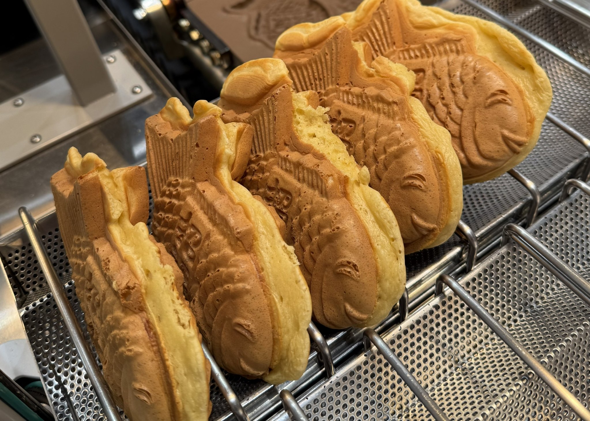 Taiyaki batter cooking in traditional fish mold