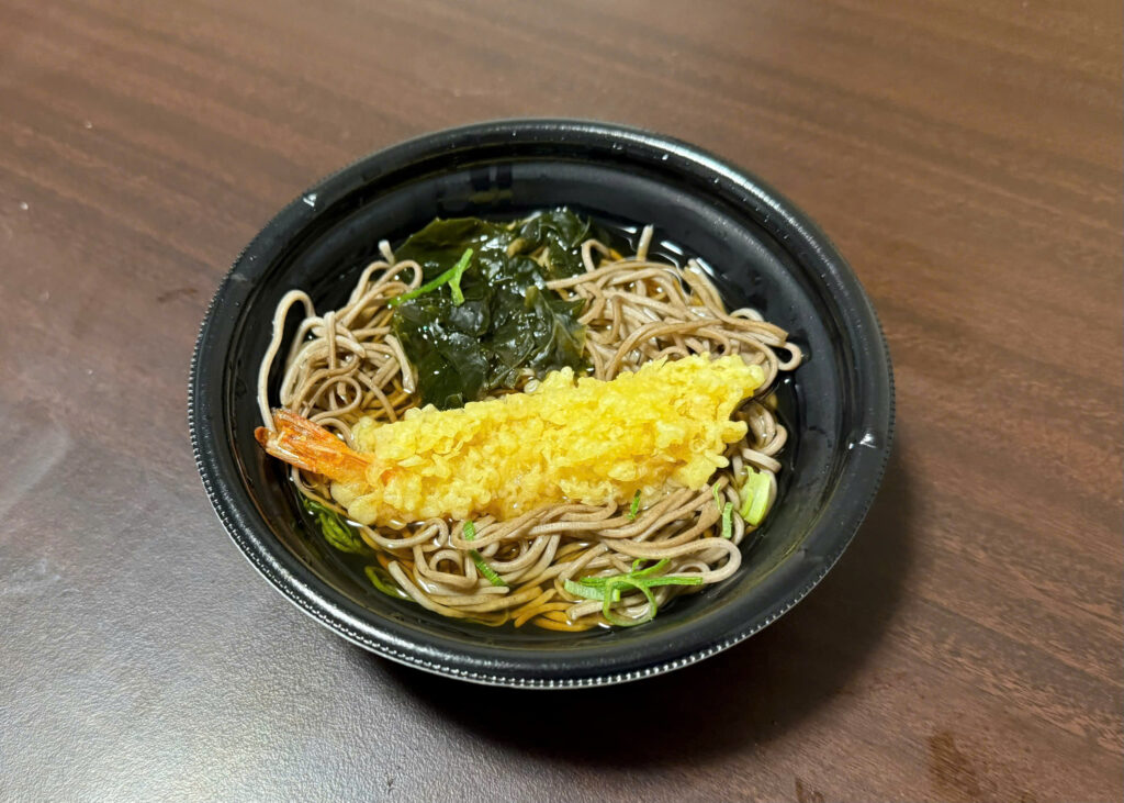 Hot bowl of toshikoshi soba with shrimp tempura, eaten on New Year’s Eve in Japan